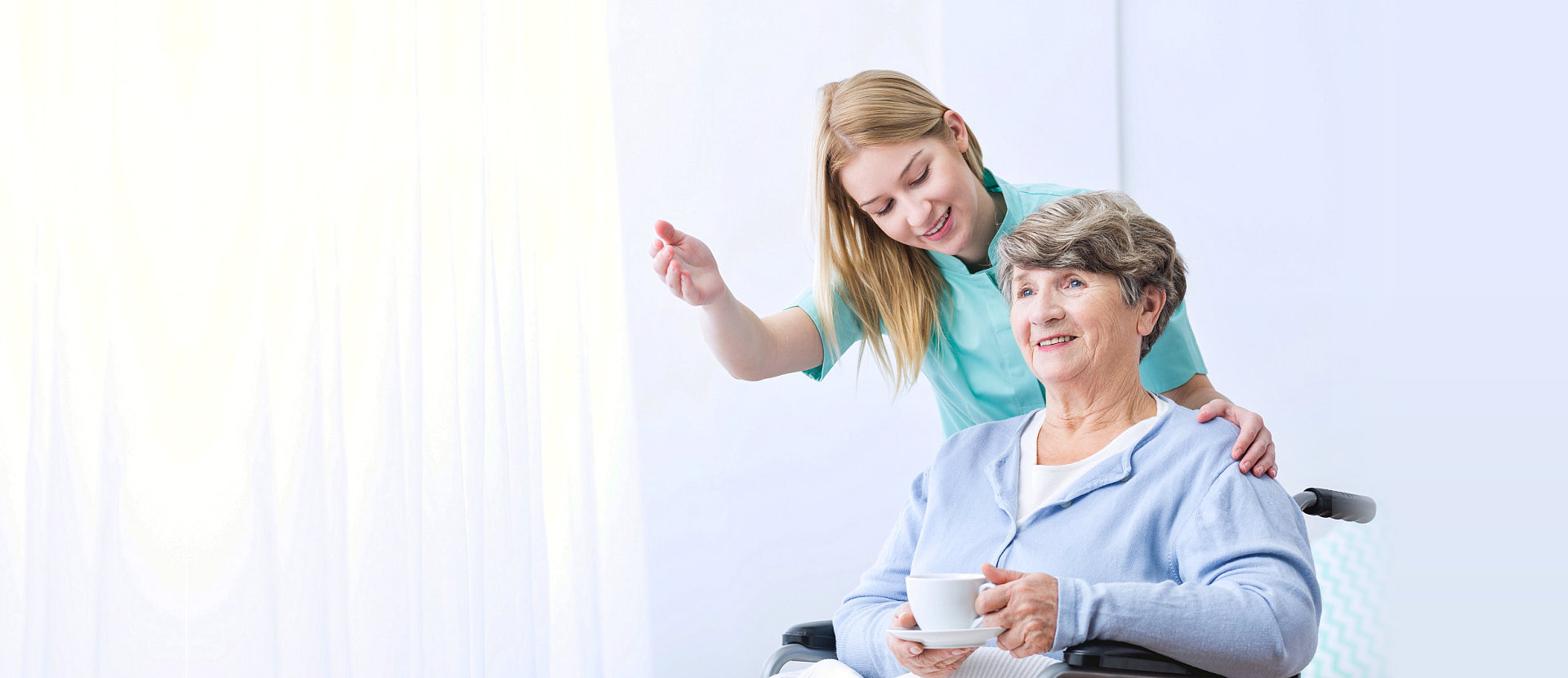 old lady in wheelchair and caretaker