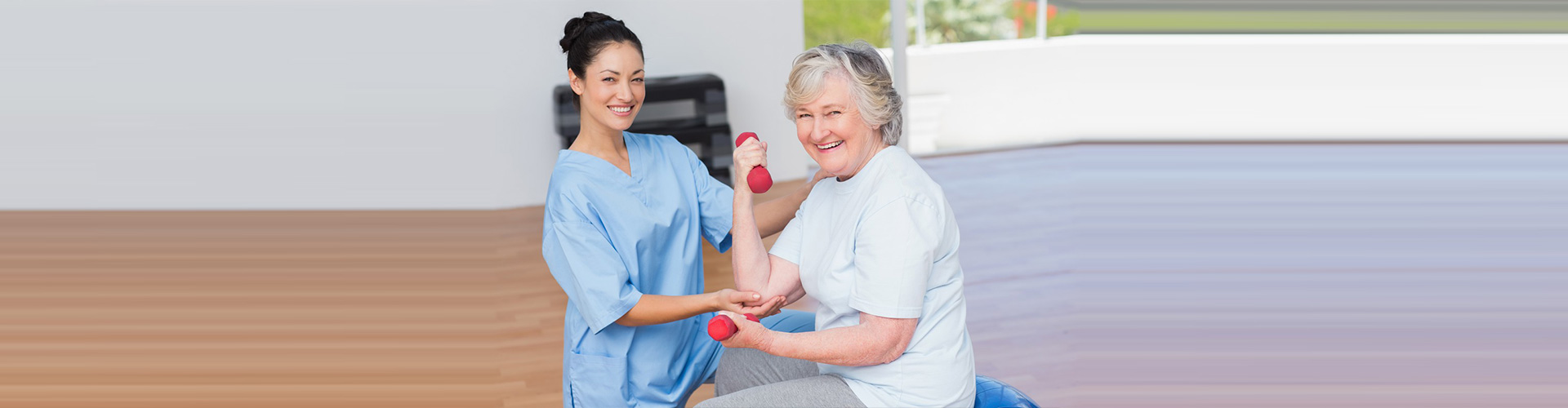 caregiver helping senior exercise